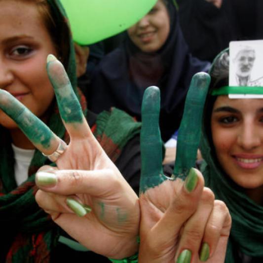 Supporters of Iranian presidential candidate Mir Hossein Mousavi show their fingers and nails painted in green, Mousavi's campaign colour, during a pro-reform electoral campaign rally at Haydarniya Stadium in Tehran on June 9, 2009. Mousavi, a former Iranian premier who has emerged as the main challenger to President Mahmoud Ahmadinejad in the June 12 election, sees himself as a "reformist" guided by the principles of the 1979 Revolution. AFP PHOTO/ATTA KENARE (Photo credit should read ATTA KENARE/AFP/Getty Images)